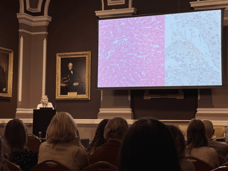 Speaker at podium at a Faculty of Pathology event